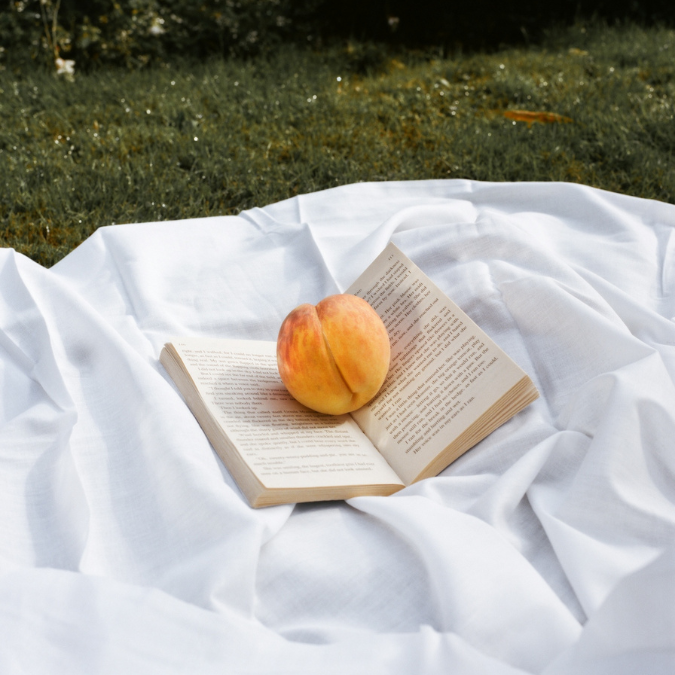 Peach on a book symbolizing a day of smut reading