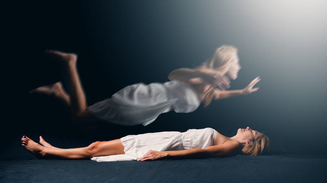 Person floating above a bed with eyes closed, symbolizing emotional dissociation and disconnection from the body during sex.